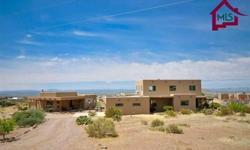 This beautiful, southwestern, custom built home can boast of its outstanding view of the Organ Mts and Valley. Main home is 2615 sq ft and features an open floor plan with vaulted tongue & groove wood ceilings in great room, a 19 ft Kiva fireplace w/banco