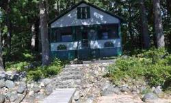 Located on the west shore of the main lake with asbolutely outstanding lake and mountain views, (awesome sunsets!) with a beautiful 100 ft sandy beachfront, wonderful 6 x 24 screened porch, this 3 bedroom camp has state approved septic, wood stove,shed