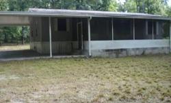 double wide mobile home on 1.99 acres, screened front porch and rear deck with 1 car carport near santa fe river.Listing originally posted at http