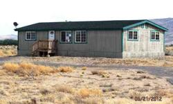 This home sits on about 4 and a half acres of land! Enjoy beautiful Nevada scenery from every direction. Home allows in plenty of natural light. The kitchen has a breakfast bar and an open area that looks over to the dining area, making a nice and open