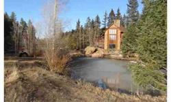 Awesome property with waterfall, ponds and stream; surrounded by mature trees and privacy; minutes from Woodland Park. Living room with Heart Stone wood stove. Dining room with wood floors and walks-out to large wrap-around deck to enjoy all of the