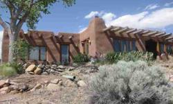 Wonderful vintage Robert Woods adobe home from 1980! This peaceful and private home is sited on a hill looking into the Sangre de Cristo and Ortiz mountains, with beautiful sunset views and located on 10+ acres in the desirable Rancho Alegre Subdivision
