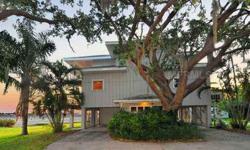 Endless sunset views of the mouth of the Manatee River, overlooking private dock in sailboat water, from various open balconies of this spacious elevated Florida home. Open kitchen and family areas allow for relaxing natural decor to backdrop the dramatic