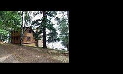 Classic Northwoods style chalet with tremendous big water views of Catfish Lake and the islands. Three bedrooms, two baths and large living room with cathedral ceiling and wood burning fireplace. Lower level features a walkout, another fireplace, and a