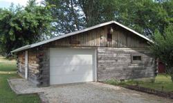 Located at 10719 Hiawatha Drive, near the waters of scenic Rocky Fork Lake, this rustic 30x30 log cabin boasts an attached garage and shop area! Constructed with 6x6 tongue and groove rough sawn logs and wood walls that are exposed creating the ultimate