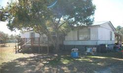 Mobile home sitting on almost 1 acre tucked away in a beautiful country setting. Home is in need of some TLC, but has much potential. 3 bedroom, 2 bath split plan with large living/family room and seperate dining area off the kitchen. Central air unit is