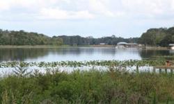 Beautiful building lot in Whispering Oaks, a deed restricted gated subdivision on Lake Josephine. Lot 51 has beautiful old oak trees and a great view of the lake. Central water is available and utilities are in. Lake Josephine is three connecting lakes