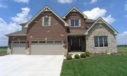 Under construction brick and stone 2-story featuring maple cabinets, stainless steel appliancess, granite in kitchen, baths and laundry, 2-story stone fireplace, crown moldings, hardwood floors, staircase with wrought iron spindles, master includes a