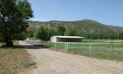 17.40 acre property on the Rio Ruidoso with horse barns and roping arena. Very nice 2700 sq. ft. 4 bedroom plus office 3 bathroom manufactured home on level acreage with gorgeous trees. This property includes 2 wells and a singlewide MH currently used as