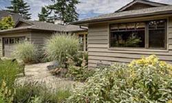 Recently renovated mid-century rambler, offers an arc of tremendous views. Pass through a delightful garden entry and into a home that was thoughtfully redesigned to create an open and versatile floor plan. Finishes include coffee colored cabinets,