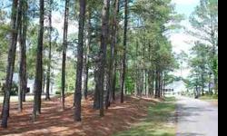 Large wooded lot along 14th hole in custom home section of golf course community. Fronted by wooded median for extra privacy. Buyer may select own builder. No timeframe for construction start. All amenities in place. Seller financing available at 6%