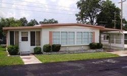 This home is in a popular subdivision known as Spanish Trails Village in Zephyrhills, Florida. It has comfortable furnishings, is centrally located, and offers a very attractive price! What more could you ask for?This furnished double-wide mobile home is