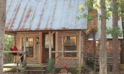 Beautiful log cabin built in the 70s in traditional saddle/notch pattern and chinked with mortar. One bedroom, one bath, living, kitchen, utility room, and outdoor shower area. Located on densely wooded 2 acre tract.Listing originally posted at http