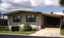 This very comfortable furnished residence is located on Granada Avenue in Spanish Trails Village in Zephyrhills, Florida. As you enter this great 2 bedroom/2 bath double-wide mobile home you first notice how completely open the front section of the