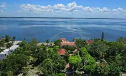 Discover "Bayside Villa," one of Longboat Key's most prominent bay front estates. As you enter through the iron gates, the paver brick circular driveway meanders through lush gardens leading you to the impressive entrance where a beautiful fountain and