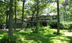 This home has a private setting on 2 acres nestled among towering oaks. It is only minutes to town. The big master suite has vaulted ceiling, fireplace and private balcony. 1st floor bedroom could be office. There is a rec room in the basement, a screen