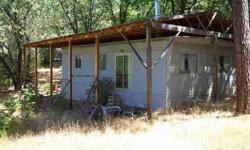 Hunters delight. This property adjoins a large BLM parcel and there are more BLM parcels within walking distance. There is a serviceable '70's era double wide mobile home which is protected from the elements by a wooden structure over it. Very near the