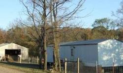 2 bedroom, 1 bathroom mobile home on .62 acres with septic and water meter, barn, fenced, in good condition. Partially surveyed. Owner Finance. Seller is motivated.Listing originally posted at http