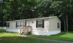 WELL MAINTAINED DOUBLE WIDE MOBILE IN A NICE PARK, 3 BEDROOMS, 2 BATHS, NATURE TRAILS, SPRING FED POND FOR SWIMMING OR BOATING, OPEN FLOOR CONCEPT, CENTRAL AIR, SOLAR SCREENS, LARGE LIVING ROOM, MASTER SUITE WITH BATH, LOTS OF KITCHEN CABINETS AND NEWER