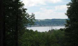 It's hard to define the terrain of this wooded lakeview lot just outside of Boyne City. There is a high-rolling hillside that slopes away to create inspiring views of Lake Charlevoix as well as great walk-out options. There is also a gentle incline to the