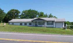 #1458R-Earth contact home with Hwy. 54 frontage. 4 BR, 2 BA, 2 utility rooms, handicapped accessable bathroom, attached 1 car drive-thru garage, septic tank, half interest in well, home was added onto in 1977, has baseboard & wall heat for backup, lots of