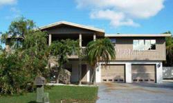 Great opportunity! Frank Lloyd Wright Inspired Home. This 2 story, 4 bedroom, 2.5 bath home has ample room to be used as a second home on beautiful Anna Maria Island. Upstairs is a split plan, 2 bed/1 bath/living room/fireplace/dining room/kitchen