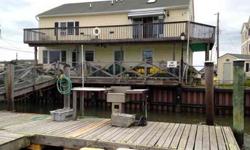 Located in the quaint island community of West Wildwood, this spacious single family offers an ideal year round living opportunity on the water, with 4 boat slips. The first floor features a large living room, formal dining room, eat-in kitchen, 2 nice