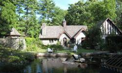 Magnificently restored Elizabethan stone cottage built in 1912 by the Singer family as a boat house. This home remains one of the few vestiges of a bygone era. Unique curved stone walls, perennial gardens,a 40x20 reflection pond and access to 100-acre