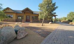 Custom home located in Whispering Canyon in the desireable Williamson Valley area just minutes from Prescott. The home is situated perfectly on the lot with an attractive paver driveway leading to a motor court. The property backs to a large common area