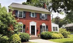 Relaxed and bright, this proudly preserved brick-front Colonial sits on a professionally landscaped corner lot. The updated interior is warm and inviting and boasts original features including natural wood trim, molding detail, arched doorways and