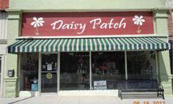 Daisy Patch Flower Shop-This successful Main St. business is located in a 2,064 square foot building that includes a retail area, workroom, backroom/kitchen, and upstairs storage. Practically everything about this building, carpet, paint, A/C, is less