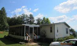 1998 doublewide on .89+/- acres lot with privacy and nice views. This home has 3 bedrooms, 2 baths home, nice large living room with fireplace and vaulted ceilings, master bath with garden tub, nice large front deck, screened in back porch and storage