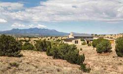 It's all about the clean lines, the natural light and the landscape. Fresh air, clear views and open space define this comtemporary home in Ranchitos de Galisteo. Overlooking the textured landscape of the Galisteo Basin, Sandia and Ortiz Mountains and the