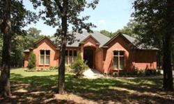 Set on 5.6 acres, 741 Oak View Drive in Eagles Landing offers an appealing custom home and spacious workshop nestled in a private wooded environment in a lakeside acreage neighborhood between Frisco and Denton. The single-story brick home features