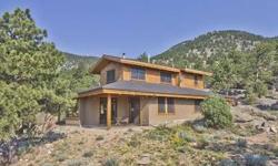 Custom designed mountain home based on work of noted Northwest architect nestled in rock out croppings on 11 acres. Incredible views of Pinewood valley, back range, urban plains. Impeccable craftsmanship. Aluminum clad, energy efficient wood windows,