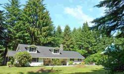 Four bedroom farmhouse located on just over six acres of property south of Florence. Main level living space has a gourmet kitchen with open dining area, French doors to the back patio, and expansive views of the Siuslaw River, Old Town Florence and
