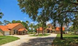 Privacy reigns in this wonderful country estate set amid 3 acres, framed by white vinyl fencing, secure gated entry and approximately 200 feet of direct frontage on sparkling, spring fed Lake Ola. This unique and rare property features a strong sculptural