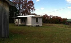 Mostly level ground located only a few miles off Hwy 111 and town. Property has some fencing in place, good 28x60 barn built in 2001 and also garage with 2 overhead doors built in 2001. Mobile is a 98 model, simple, clean, has a covered front porch. Just