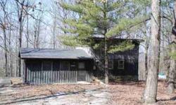 Secluded cabin w/5 acres. Living room w/fireplace, large eat-in kitchen, deck, 1 bedroom , 1 bath upstairs with a private balcony for enjoying the views of the mountain. Additional acreage priced $4,000 an acre with the sell of the cabin and 5