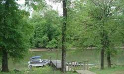 Great waterfront lot with dock on Hardins Creek with access to the Tennessee River located in the Cobb Farm Resort. Building site out of flood zone, water on property. Restrictions apply.Listing originally posted at http