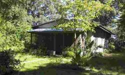 Very affordable "as is"/"fixer-upper" frame-blt. home, on a secluded 1-acre tract in West Gilchrist Co. (right by the Wilcox curve intersection, of SR-26 & CR-232, just North of Fanning Springs). Home has a solid base, but will need some inside 'TLC', but