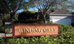 SEASONAL VACATION RENTAL. Longboat Keys most desirable gated community. Enjoy lakefront views in this turnkey furnished villa "behind the gates" in Winding Oaks. A secluded garden entry leads into a spacious 2-bedroom and 2-bath residence with attached