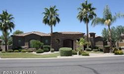 Gorgeous custom 3 bed/den home in gated community has beautiful park-like yard and includes landscape lighting, pool, gas fireplaces, firepit, TV, speakers, misting system, and citrus trees. Fully paid for solar panels installed in 2012 will keep your