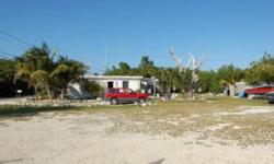 Attention all investors!! 120.92' of Overseas Highway Frontage AND 132' of Water Frontage; this is a diamond in the rough with multi faceted development possibilities. 2 lots, nearly 1 acre of land, amazing location, just across the highway from