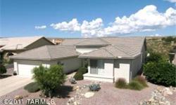 Beautiful modified Ponderosa model. A wall of windows overlooking the natural desert greets you the moment you enter this pristine home. The large great room design with formal dining room is ideal for all your entertaining needs. The gourmet kitchen