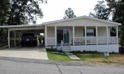 BEAUTIFULHOME! This three bedroom, two bath double wide was built in 2008, offers 1440 sq feet of living area and features an open plan with split bedrooms, open living and kitchen area and is sited on a double lot with a storage building, carport and a