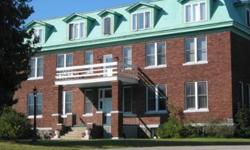 Perched on a St.Ignace park-like bluff setting is this stately 1914 brick building, formerly the St. Ignatius Loyola Ursuline Academy. This main level corner unit has south and east exposures and features 10 ft. ceilings, semi-private deck and is handicap