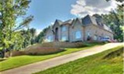 No expense spared in this magnificent all brick home set high on a hill overlooking the lake in private and gated Liberty Lake Estates. Every room brings new surprises and elegance with Brazilian Cherry and Walnut floors, Swarovski Chandeliers and light