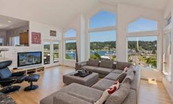 Towering windows frame sparkling views that define the uncomplicated appeal of this amazing Gig Harbor home. Cathedral ceilings, marble fireplaces and open living areas combine with a unique setting overlooking Gig Harbor to create a breathtaking home