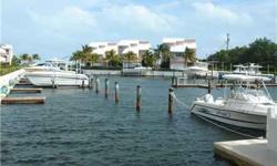 Tropical Paradise in Key Largo! This Beautiful Tri-level featuring 2/2 on second floor, Lg Loft with own bath on third level + 2 docks, double car port is a perfect second home getaway! This exclusive and private gated community of 24 Townhomes on the